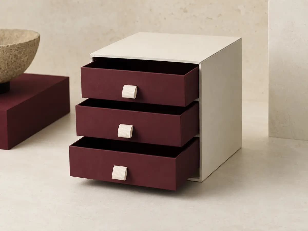 Custom drawer and sliding box collection in ivory and burgundy with ribbon pulls