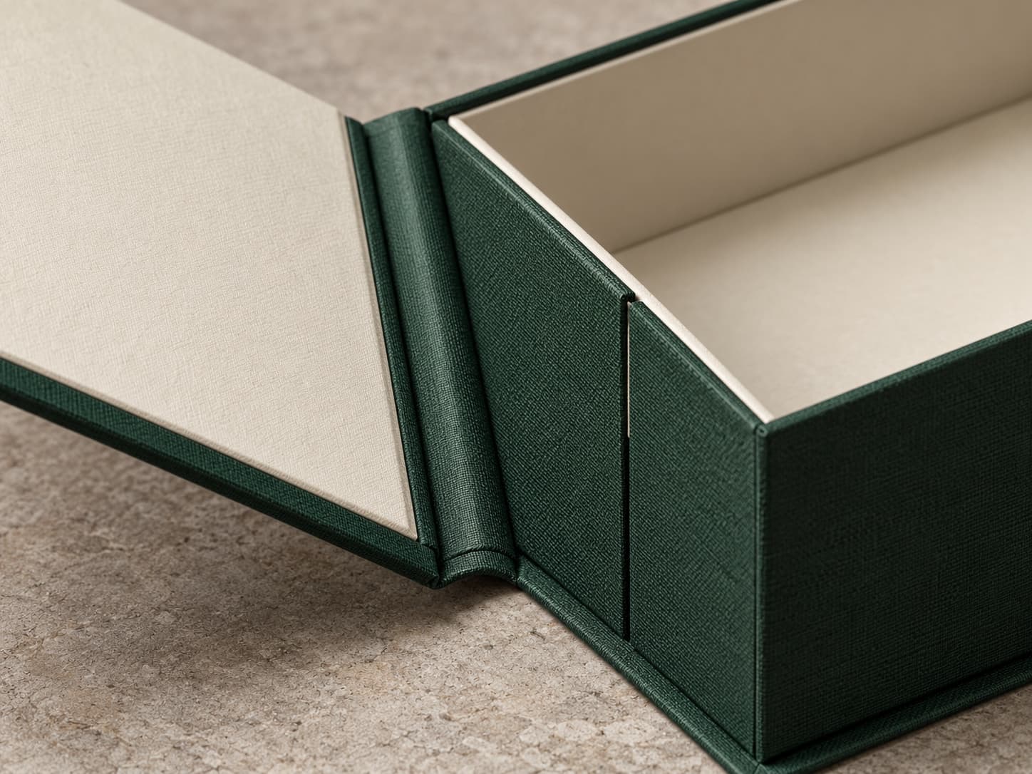 Concept close-up showing wrapped spine, hinge and cover edge on a book-style rigid box
